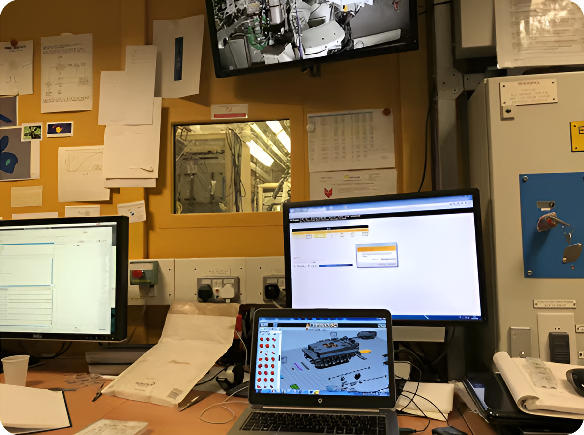 Research desk with monitors showing a virtual brick tank model