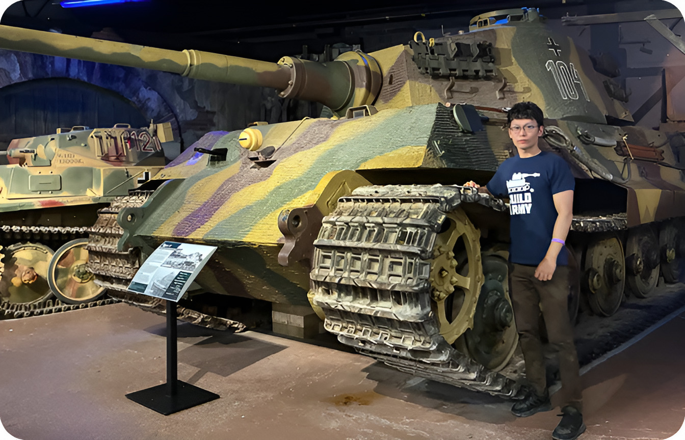 Buildarmy founder standing beside a Jagdtiger tank in a museum